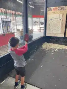 Child throwing an axe