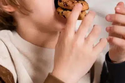 Child stuffing cookies into their mouth