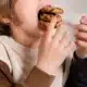 Child stuffing cookies into their mouth