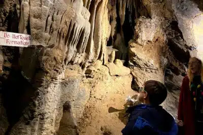 Child looking at a rock formation in a cave