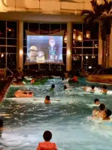 Watching a movie from an indoor pool