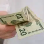 Hand holding a $20 bill