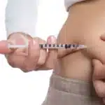 Woman injecting herself with medication