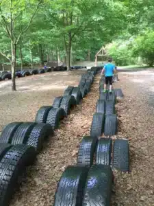 Little boy playing on reused car tires