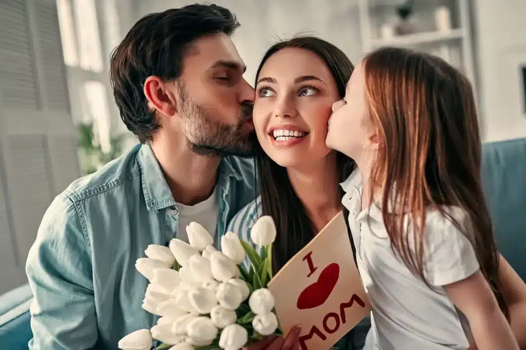 Father and daughter kissing mom and celebrating Mother's Day