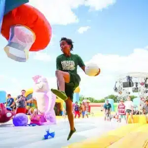 Boy performing a slam dunk on an inflatable hoop