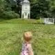 Little girl in field by pavillion