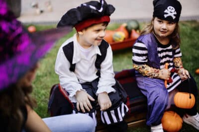 Children play at a Halloween party in the garden, backyard.