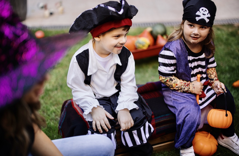 Children play at a Halloween party in the garden, backyard.