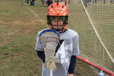 Young boy in lacrosse gear