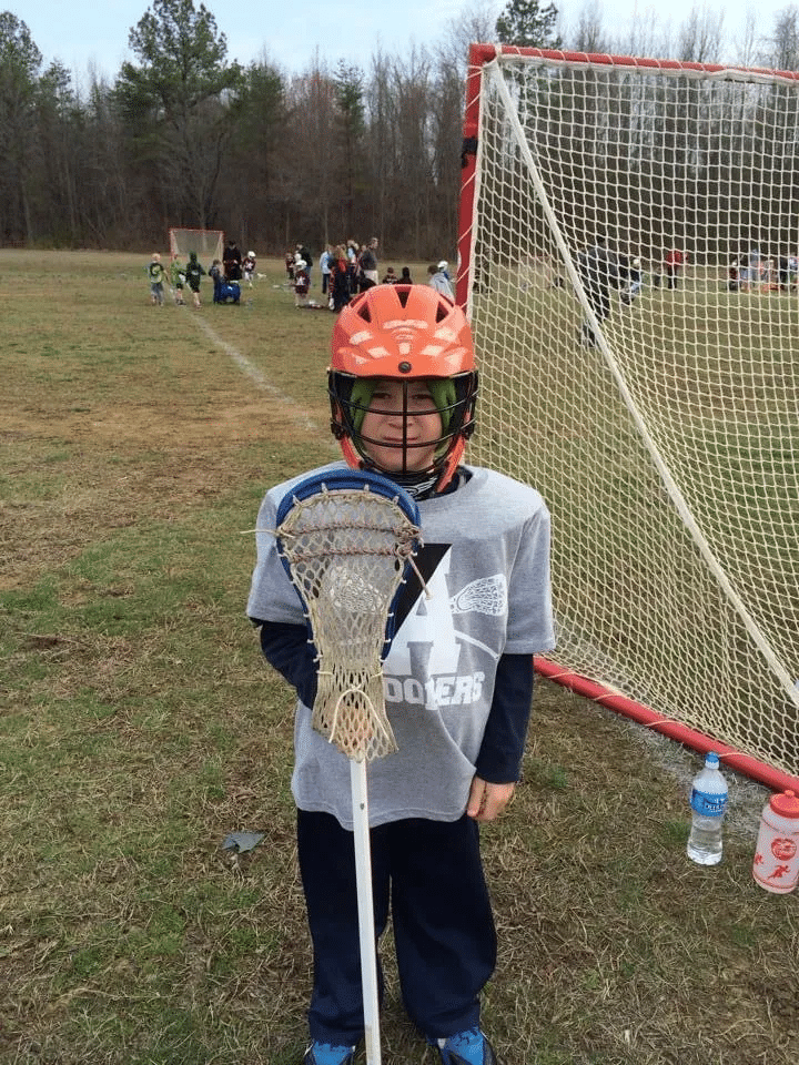 Young boy with lacrosse gear