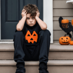 Young boy sad on steps halloween