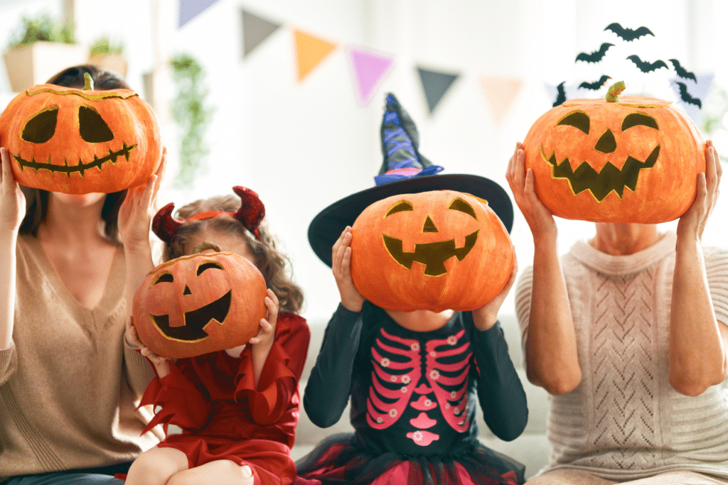 Kids in Halloween costumes with holding jack o' lanterns