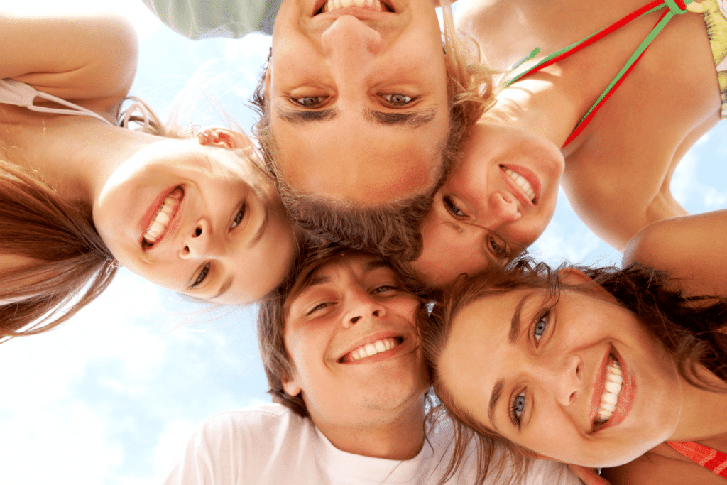 teens in a circle smiling