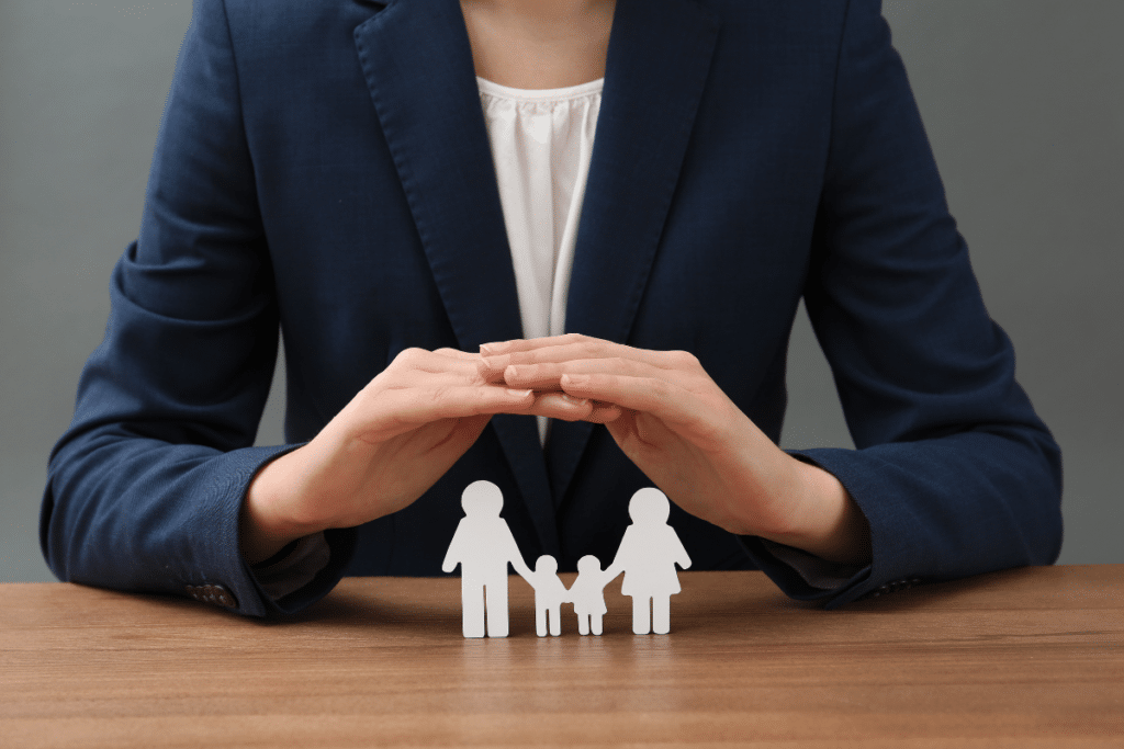 woman using hands to cover paper family