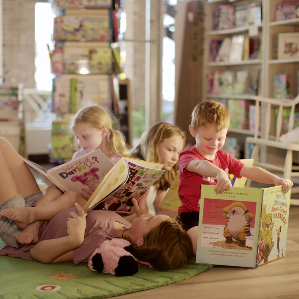 4 kids reading on the floor