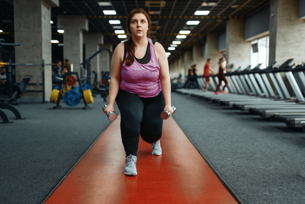 Overweight women exercising with dumbbells