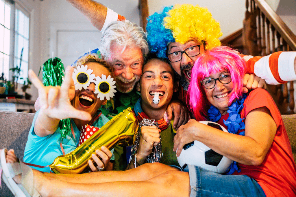 family smushed together at couch wearing fun wigs and smiling