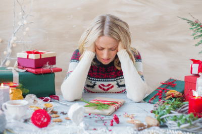 mom overwhelmed wrapping Christmas gifts