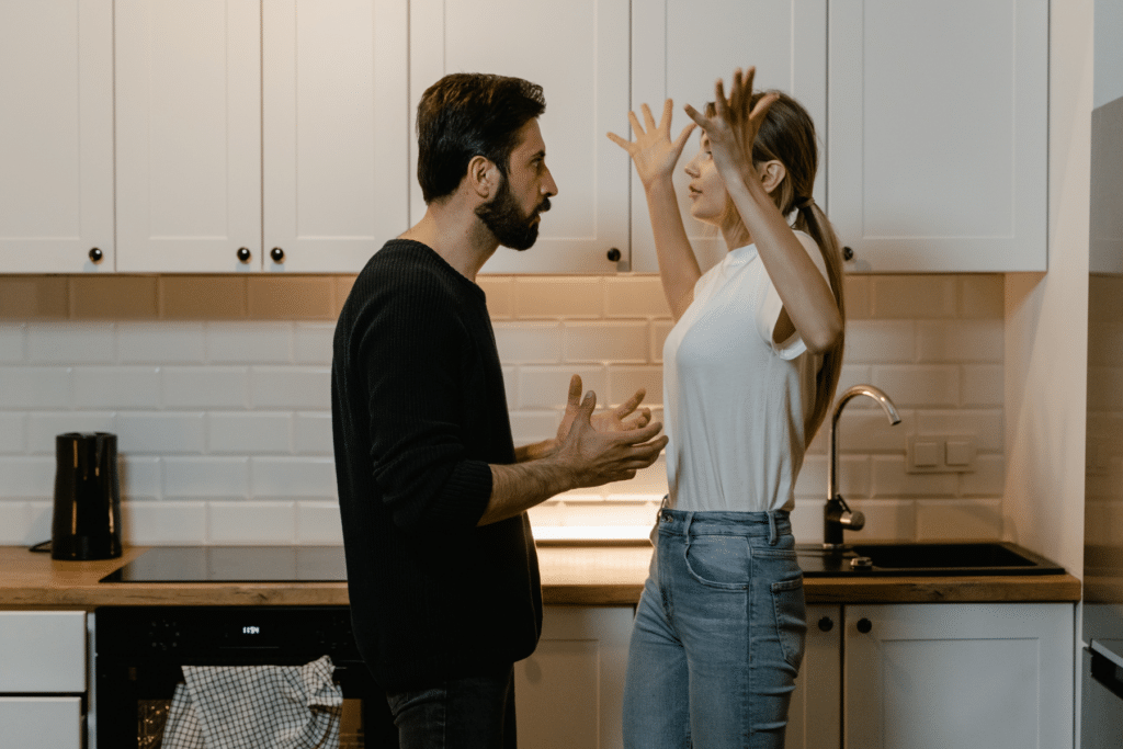 a couple arguing in a kitchen man and woman married