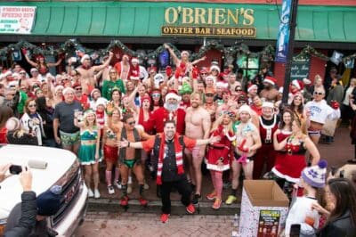 Crowd of people dressed in speedos and santa attire