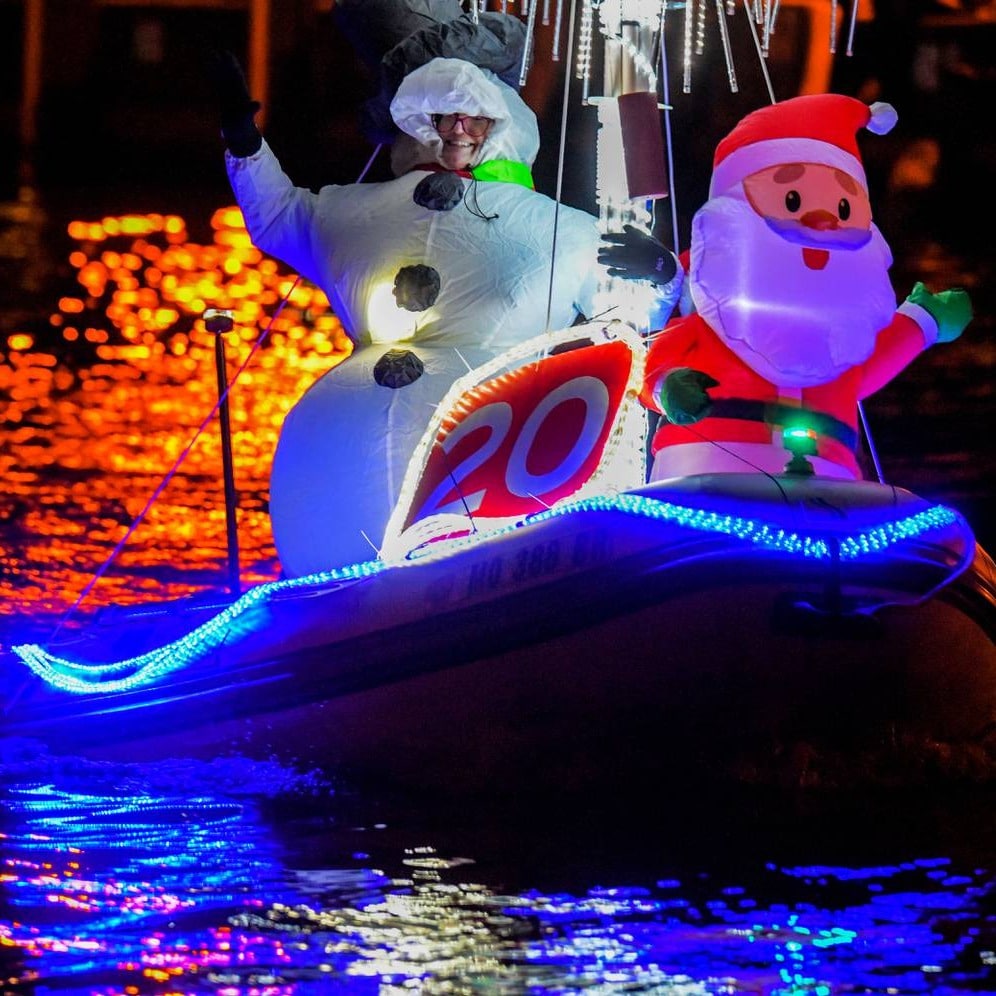 a lighted Rubber dinghy with snowman and santa waving