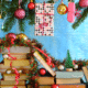 stacks of books under a pine tree and Christmas ornaments strewn over the books