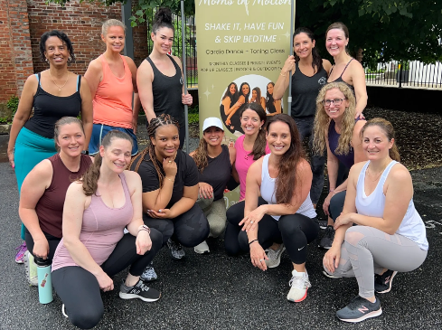 a group of women standing and squatting, posing for the photo