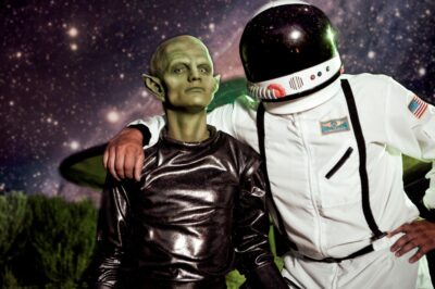 An alien and an astronaut posing together for the Alien Adventure Escape Room