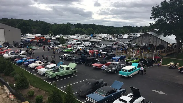 Picture of fancy, older cars in a parking lot for the Bring Your Wheels to Deale event at the Boathouse at Anchored Inn.