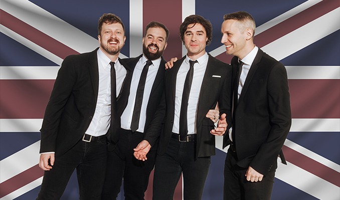 men in suits in front of British flag