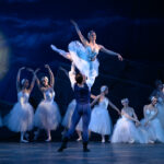 Ballet Theatre of Maryland dancer Lindsey Bell and guest artist Jackson Kettell pose in front of the Swan Corps de Ballet in Swan Lake.