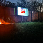 Fire pit with movie screen in the background.