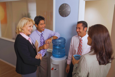 Workers chatting around water cooler