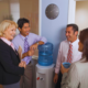Workers chatting around water cooler