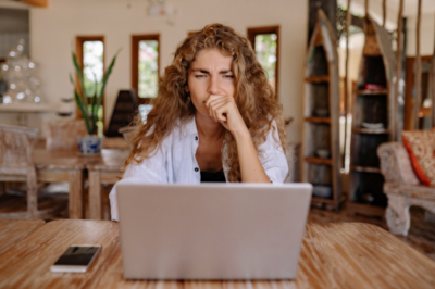 Frustrated woman looking at laptop