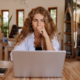 Frustrated woman looking at laptop